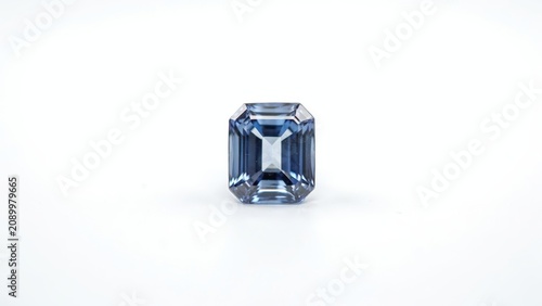 Sparkling blue emerald cut gemstone isolated on a white background