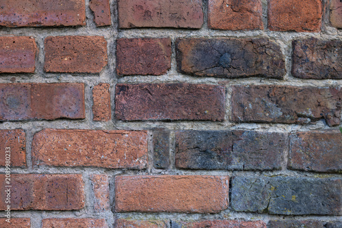 Fotografie Background of old red and blue bricks in a wall