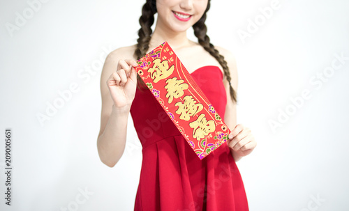 Cuadro en lienzo Young woman holding traditional Chinese New Year blessing banner