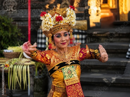 Traditional Balinese Dancer in Golden Costume with Floral Headdress