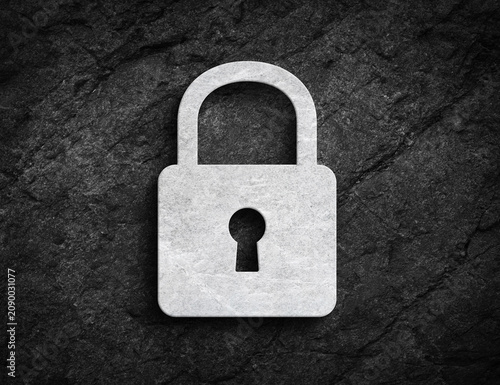 Closed padlock security symbol carved on stone wall