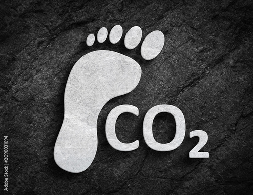 Carbon footprint CO2 symbol on dark stone wall