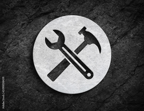 Wrench and hammer repair symbol carved on stone circle