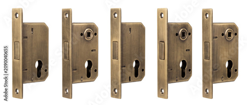 Mortise lock body brass mechanism isolated on black background for home security and interior hardware installation featuring durable vintage bronze metallic construction in a clean row alignment set.