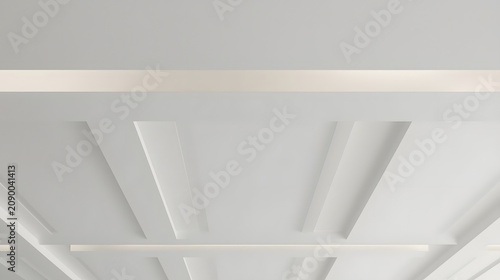Modern white ceiling with recessed lighting and geometric paneling creating a sophisticated interior design.