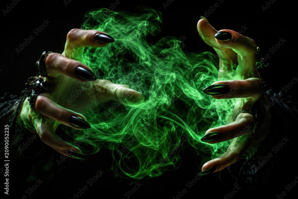 Fototapeta premium Dark sorceress hands casting green glowing magic spell in black void background now
