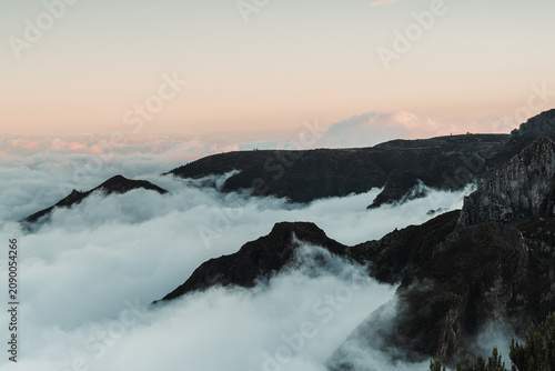 Sunset over the mountains. Mountains shrouded in clouds