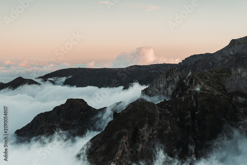 Sunset over the mountains. Mountains shrouded in clouds
