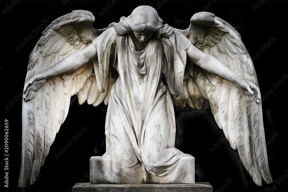 Obraz premium A marble angel statue stands praying beneath on black. Spiritual guardian of faith, devotion, hope, protection, memorial, serenity and religious art. Funeral, burial.