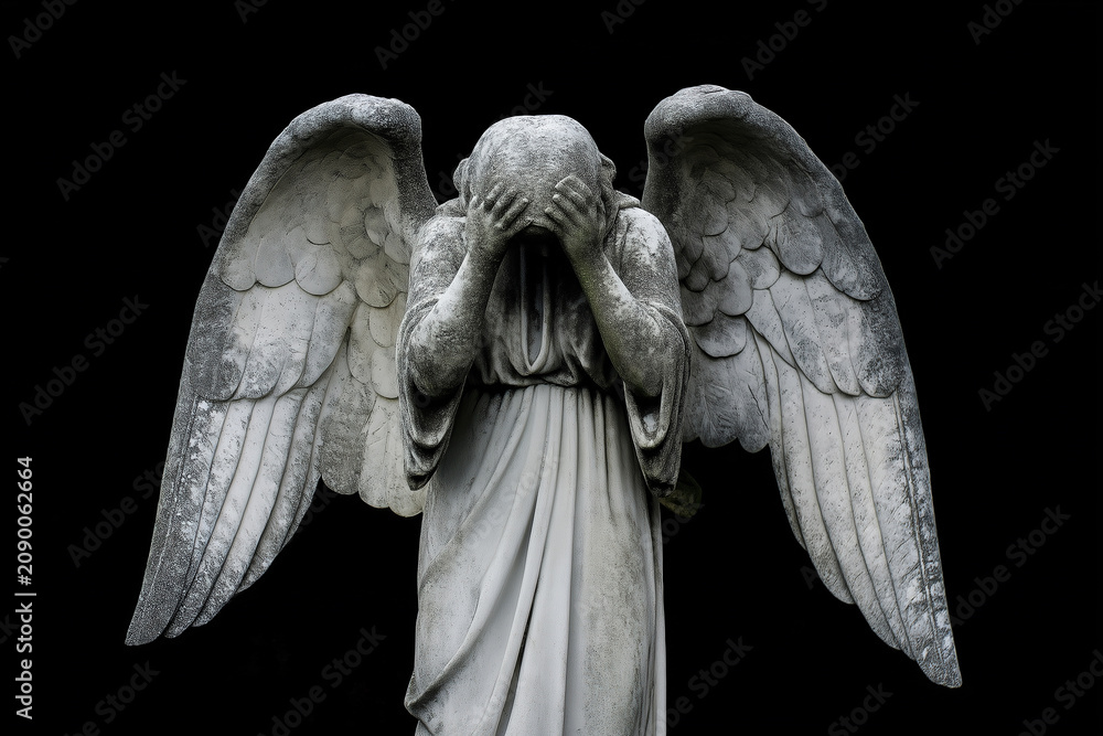 Obraz premium A marble angel statue stands praying beneath on black. Spiritual guardian of faith, devotion, hope, protection, memorial, serenity and religious art. Funeral, burial.