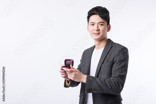 Photography Young man holding open ring box ready for marriage proposal