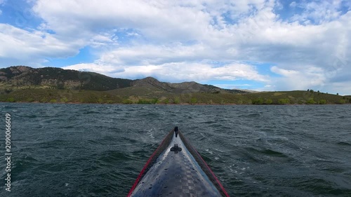 Immersive POV kayaking across Horsetooth Reservoir in Fort Collins, Colorado, while paddling into a strong headwind. Experience challenging summer conditions as a carbon fiber kayak cuts through waves
