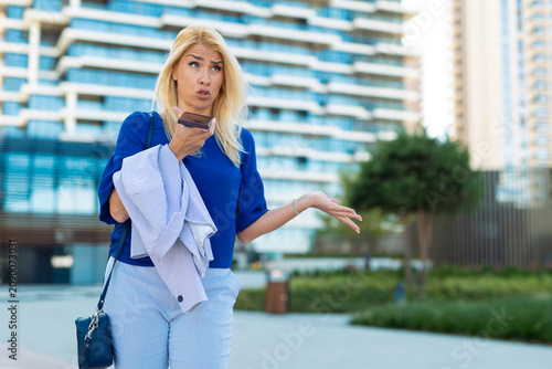 Woman having confused phone call feeling frustrated