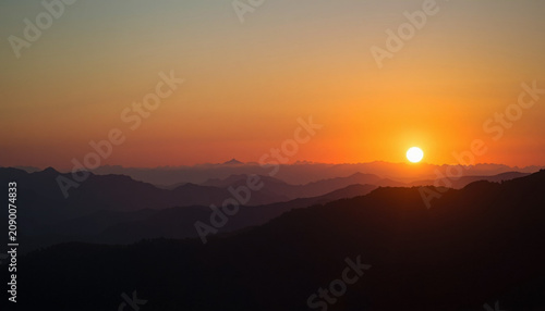 Golden Sunrise Over Mountain Silhouettes with Layered Landscape Panorama