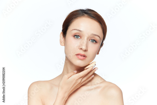 Konstfotografi Natural beauty portrait of young woman touching her face with clean makeup