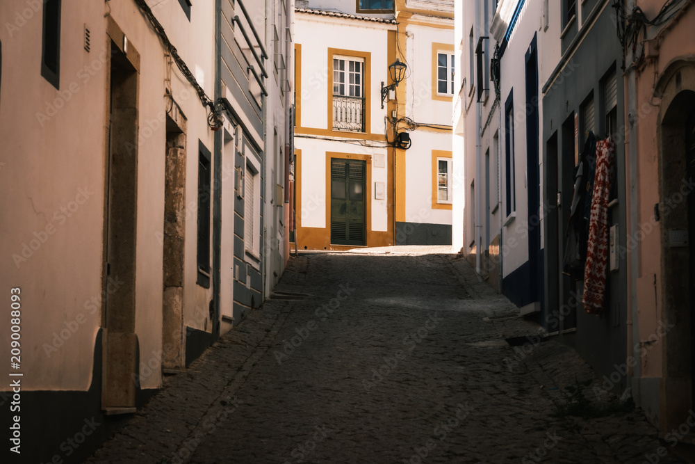Fototapeta premium From the narrow cobblestone alleys of Lagos Portugal, Algarve. Charming street with whitewashed old houses. 