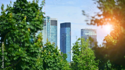 Building surrounded with green trees.  Eco-friendly building. Sustainable architecture of city reducing heat carbon dioxide modern city environment.