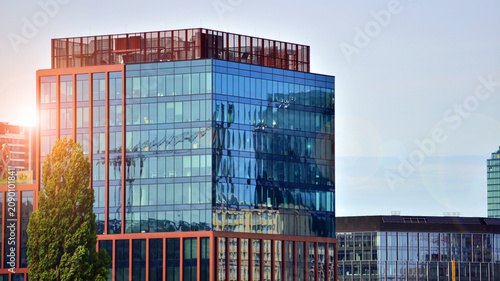 Building surrounded with green trees.  Eco-friendly building. Sustainable architecture of city reducing heat carbon dioxide modern city environment.