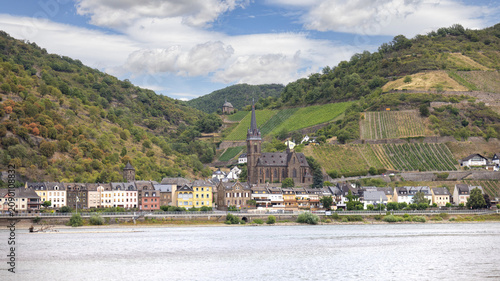Historic village of Lorchhausen with vineyards on the Rhine River in Germany.Scenic panoramic view of the historic villages of Lorch and Lorchhausen with vineyards, church and rolling hills along the 