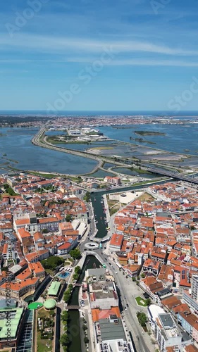 Panoramic drone shot over Aveiro city, historic river and floating boats