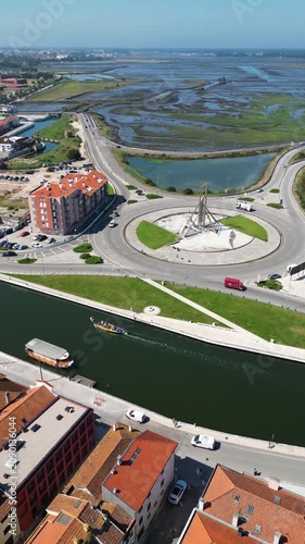 Drone tracking shot of boats navigating the river in Aveiro city center