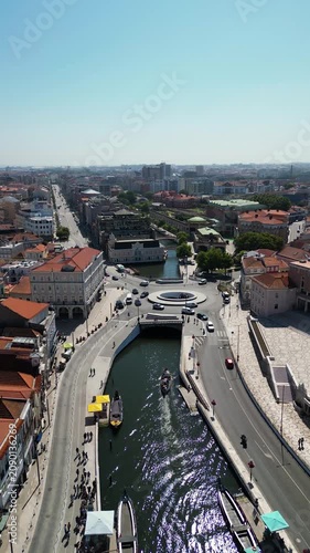 Aerial drone perspective of Aveiro city urban center, river and boats