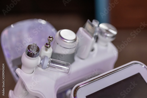Konstfotografi Professional multifunction facial skincare machine with interchangeable treatment attachments for advanced cosmetic procedures in a modern beauty clinic