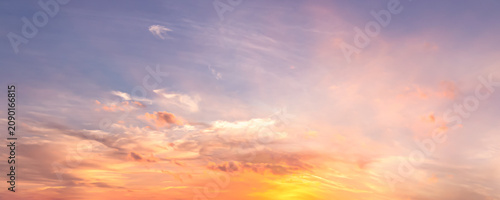 Beautiful sunset sky background with soft pastel pink purple clouds and bright golden sun glow for panoramic travel mockup design