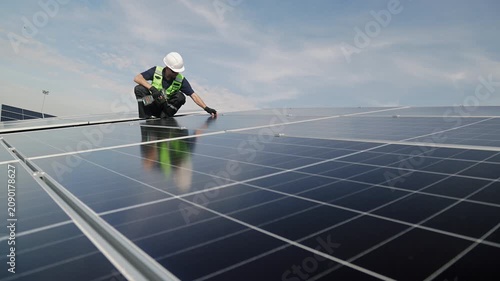 Technician installing rooftop solar panels for green energy, supporting renewable energy, clean power, sustainable technology and solar infrastructure.
