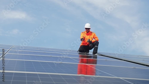 Technician installing rooftop solar panels for green energy, supporting renewable energy, clean power, sustainable technology and solar infrastructure.