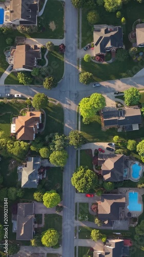 Vertical screen. Aerial perspective of suburban area Johnson City, Tennessee, featuring neatly arranged homes, green lawns swimming pools tranquil environment community layout of neighborhood