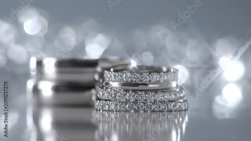 Elegant Diamond Wedding Rings on Reflective Surface.