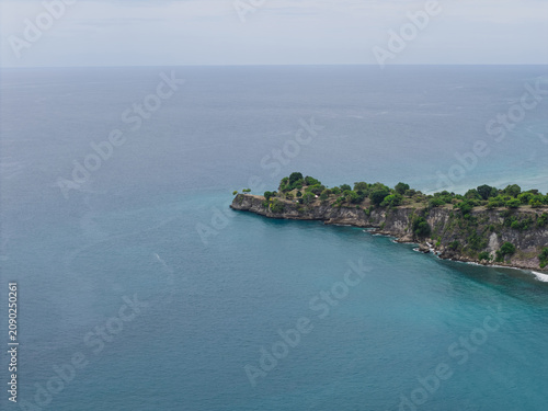 Aerial View of Rocky Green Headland Jutting Into the Vast Ocean in Aceh, Sumatra