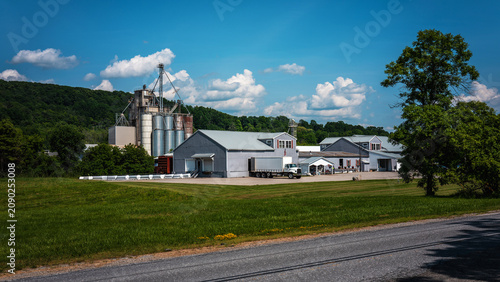 Tranquil New England summer road travel landscape with industrial factories and buildings along the highway through the Green Mountain National Park area in Middlebury, Vermont, USA