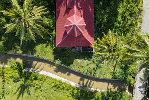 Red-Roofed Building, Canal, and Road in Tropical Village in Aceh, Sumatra, Indonesia