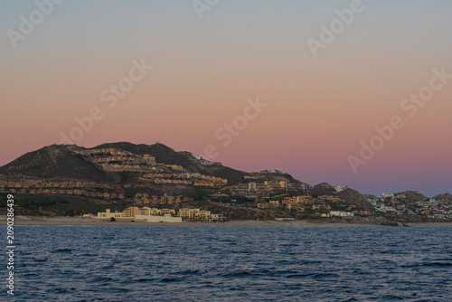 resorts along pacific coast of cabo san lucas mexico at southernmost tip of baja california peninsula during twilight