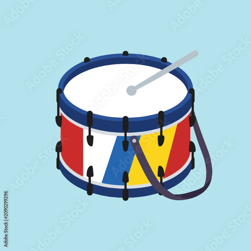 A colorful toy drum sits against a light blue background