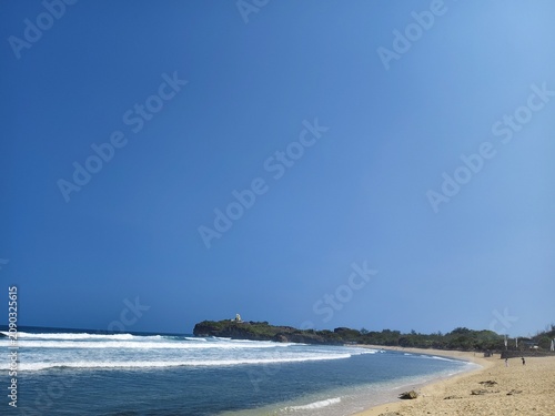 Minimalist ocean view with gentle waves under a clear blue sky with copy space