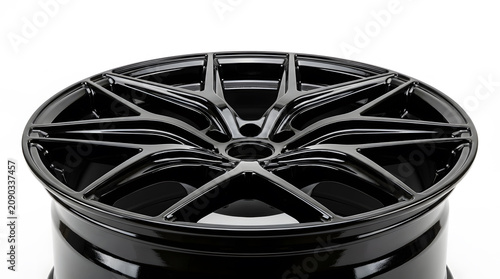 Close-up of a modern glossy black alloy car wheel rim isolated on a white background