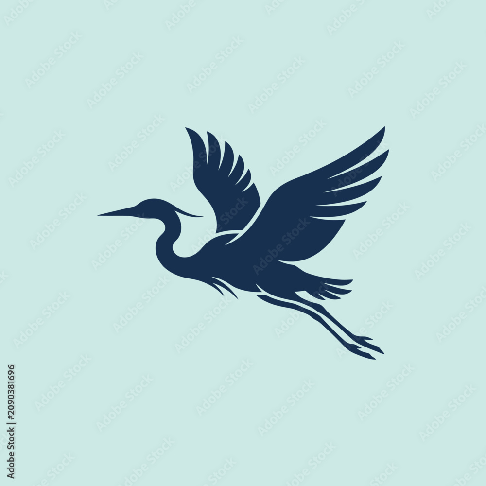 Fototapeta premium A dark blue heron silhouette flies in the sky