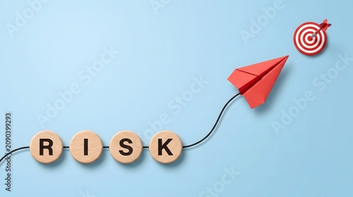 Wooden Discs Spelling Risk with Red Paper Airplane Flying to Dartboard Target Business Growth Strategy Concept
