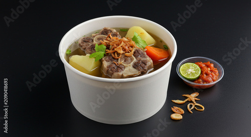 Indonesian Oxtail Soup in Takeaway Bowl with Sambal and Lime