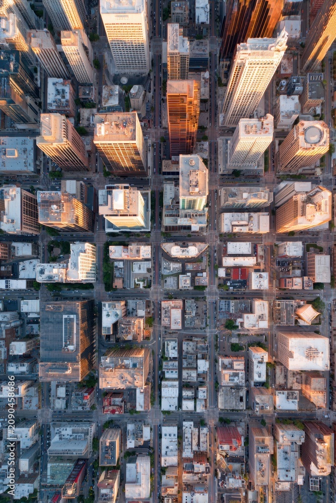 Fototapeta premium View from above showing city skyline at sunset highlighting buildings, streets, and urban layout in a major metropolitan area