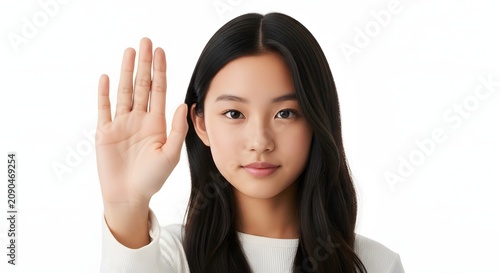 Portrait of a young asian woman holding her hand up in a stop gesture isolated on white background