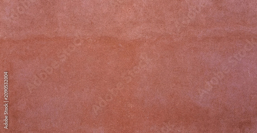 Bild auf Leinwand A textured background featuring a warm terracotta color with subtle variations in tone