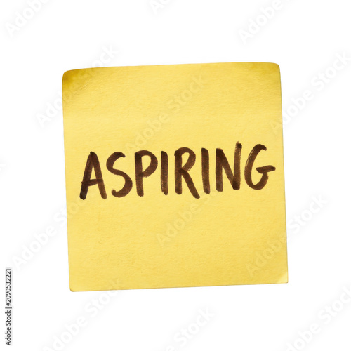Yellow adhesive note with handwritten aspiring text on transparent background