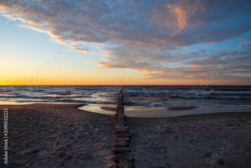 Dramatic sunset on the beach in Dziwnow, Poland