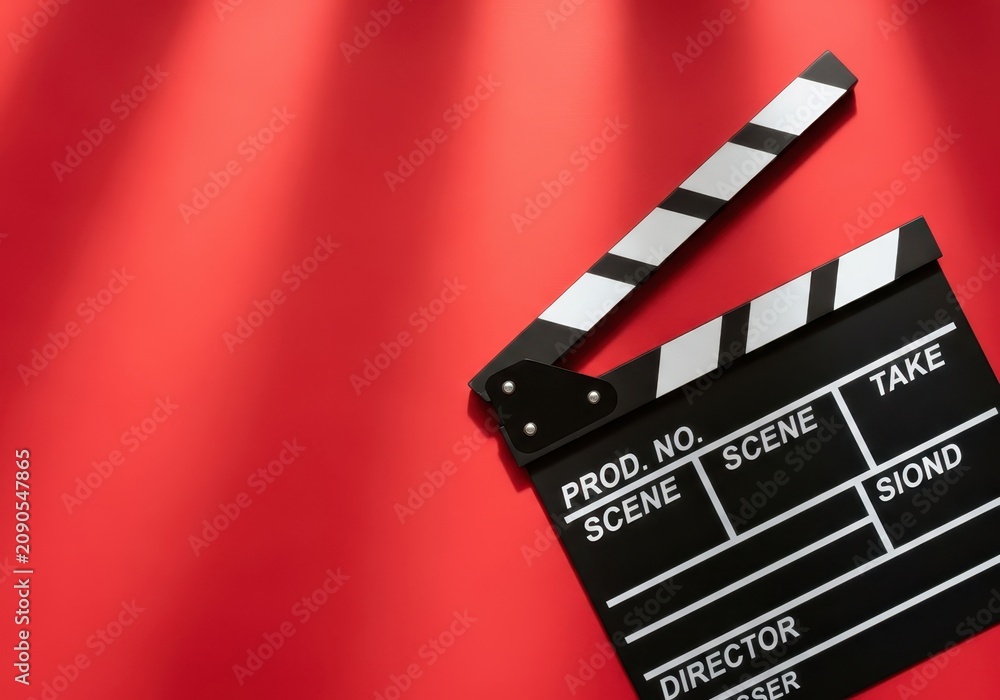 Naklejka premium Professional Film Slate Clapperboard on Vibrant Red Background with Dramatic Lighting and Copy Space