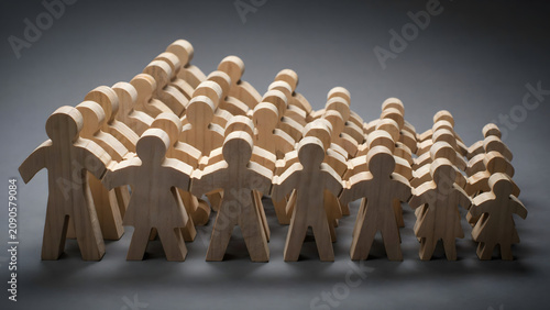 Group of wooden human figures arranged in a descending staircase pattern