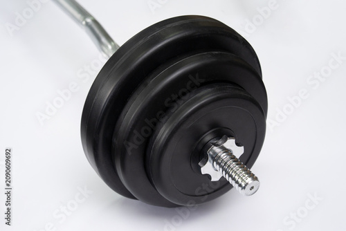 Photos Close-up of barbell weight plates with star lock collar on white background